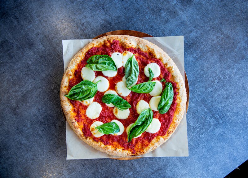 Green lantern pizza signature margherita pizza fresh from the wood-fired oven